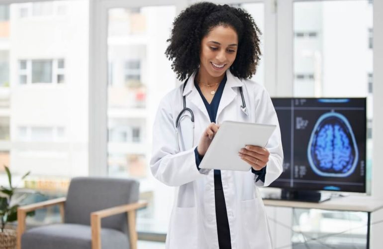 Surgeon reviewing operative notes and medical billing codes for neurosurgery procedures.