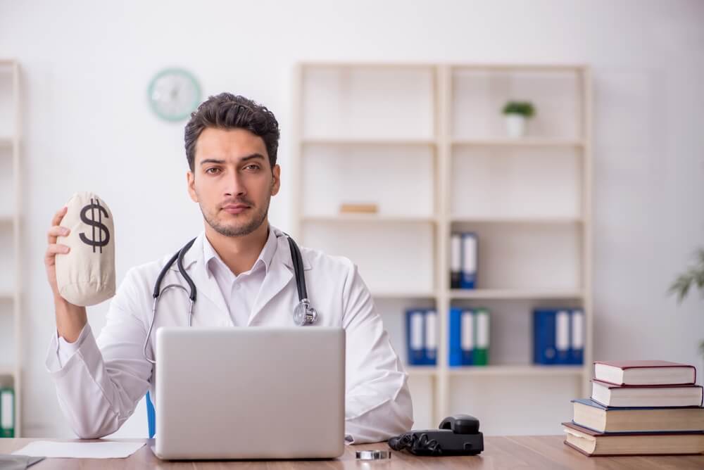 Internist reviewing patient records and medical billing documentation for accurate reimbursement