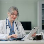 Healthcare billing specialist reviewing insurance payments and EOB during payment posting process