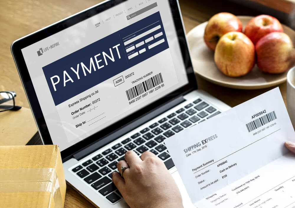 Payment posting specialist manually reviewing explanation of benefits and posting payments into system