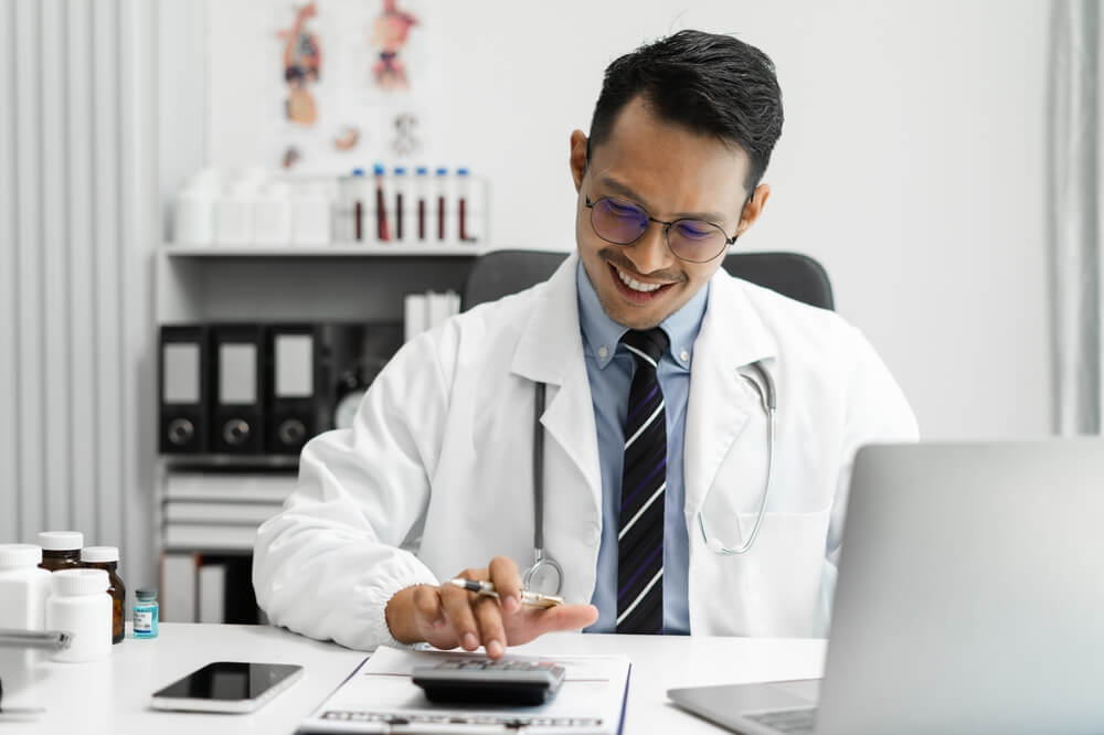 Medical billing staff reviewing an ERA file on a computer screen for accurate payment posting.