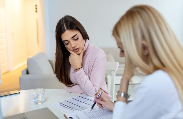 Medical billing professional reviewing insurance documents and Explanation of Benefits statements in office setting