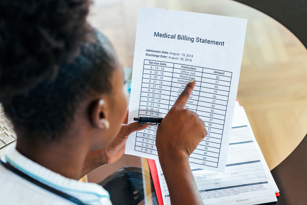 Doctor providing a superbill document to patient for insurance reimbursement