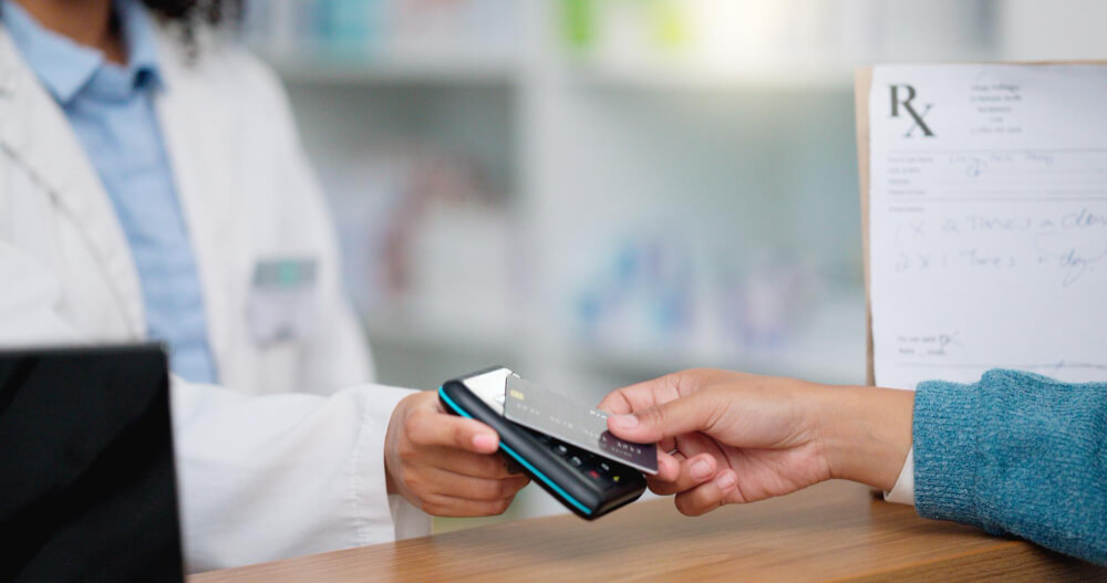 Patient making a medical payment while reviewing hospital billing and insurance coverage details.